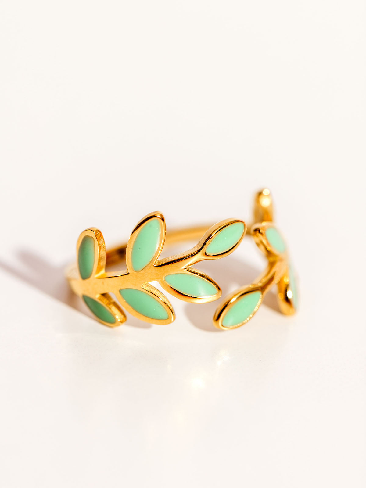 Seeds of Hope Ring on white. Ring feature blue and gold leaves.