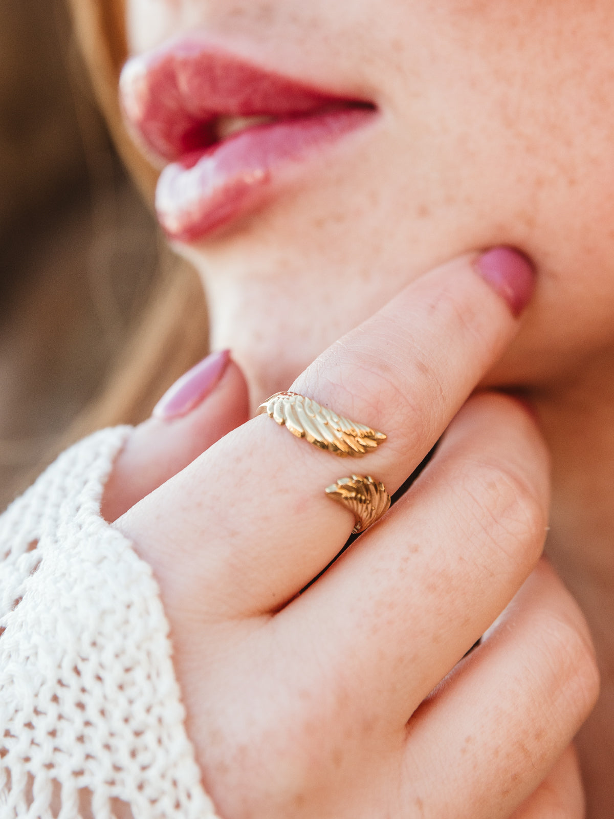 close up of female model wearing Gold Birds of the Same Feather Ring .
