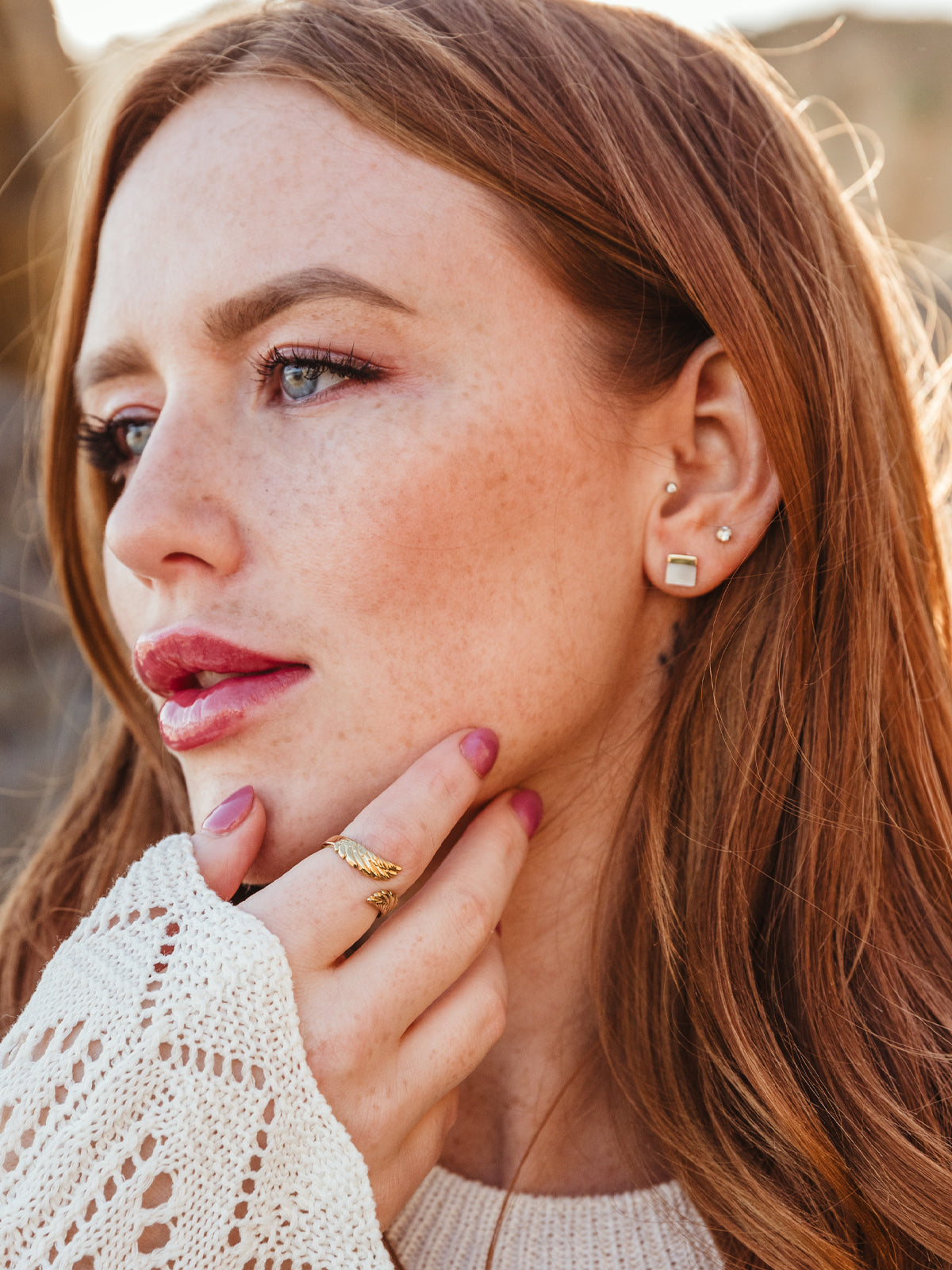 Portrait of female model with red hair wearing female model with red hair wearing Kelly Mother of Pearl Stud Earrings.