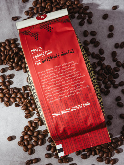 Back of Vinculo Coffee Su Casa blend bag featuring their mission: “Coffee Connection for Difference Makers,” with global impact messaging and a bold red design.