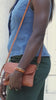Model showing 3 ways to wear the brown leather crossbody clutch.