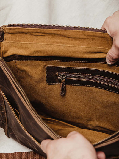 Interior of travel bag featuring carmel cloth interior and leather zipper for additional storage. 