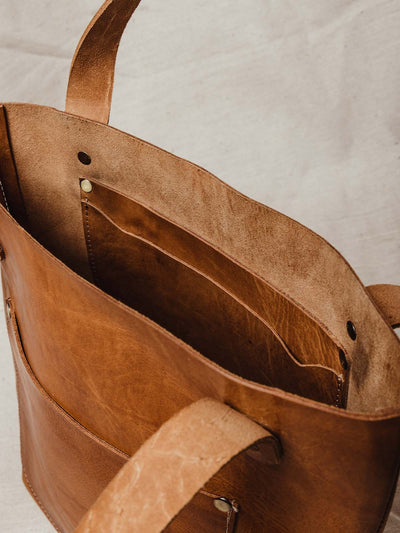 Interior of hazelnut colored leather handbag with large interior pocket of extra storage. 