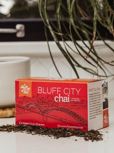 Chia Tea box on counter with coffee cup and greenery.