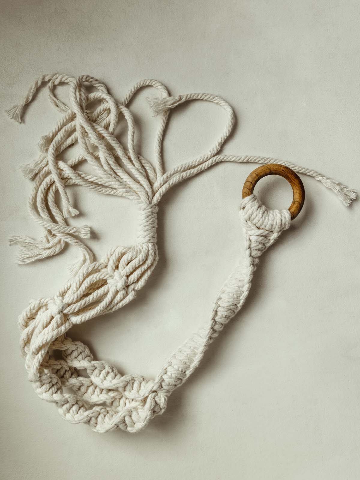 Macrame plant hanger on a white table