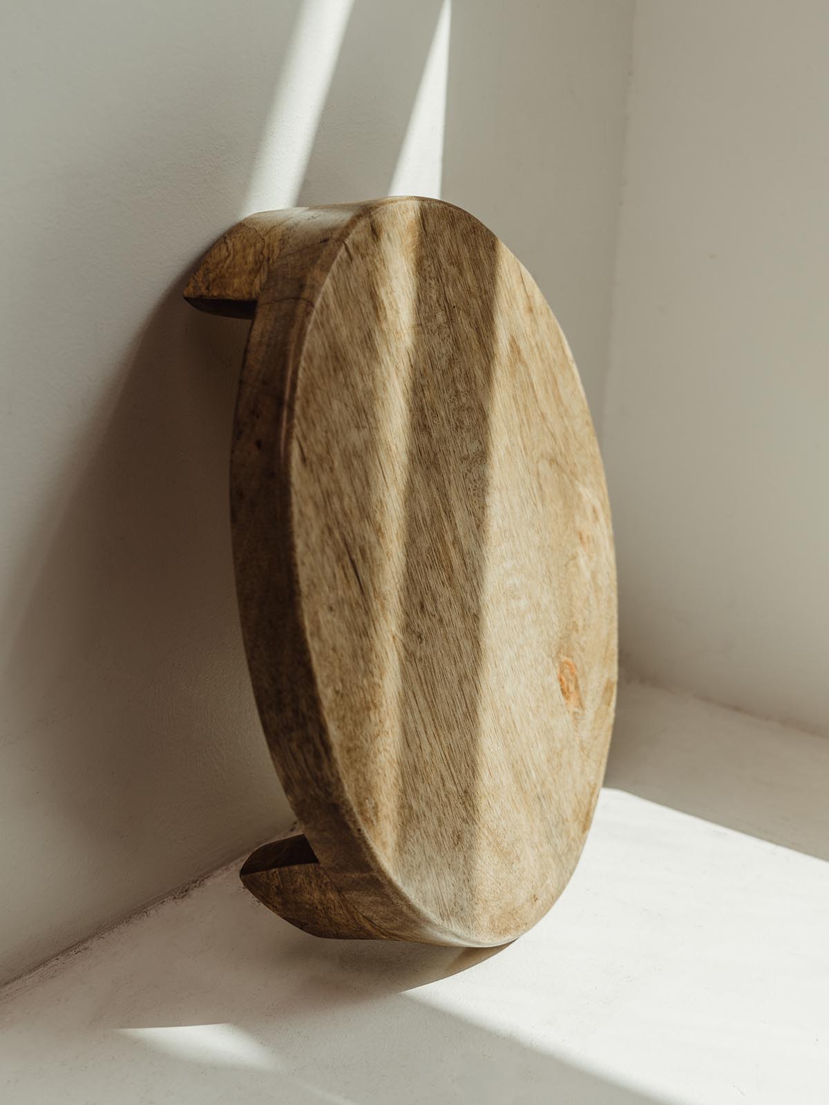 wooden footed tray against a white table