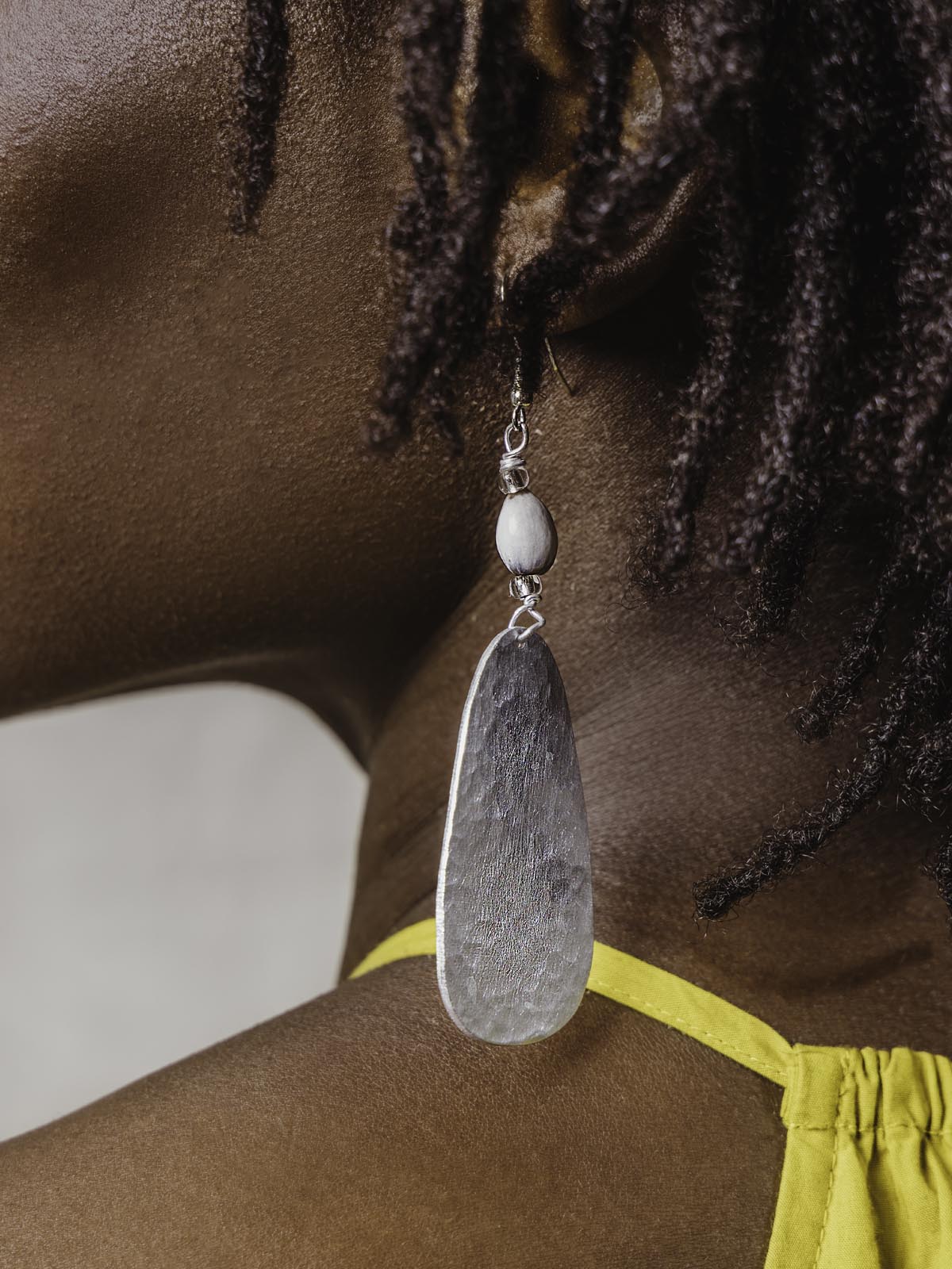 close up of Aluminum earrings on model