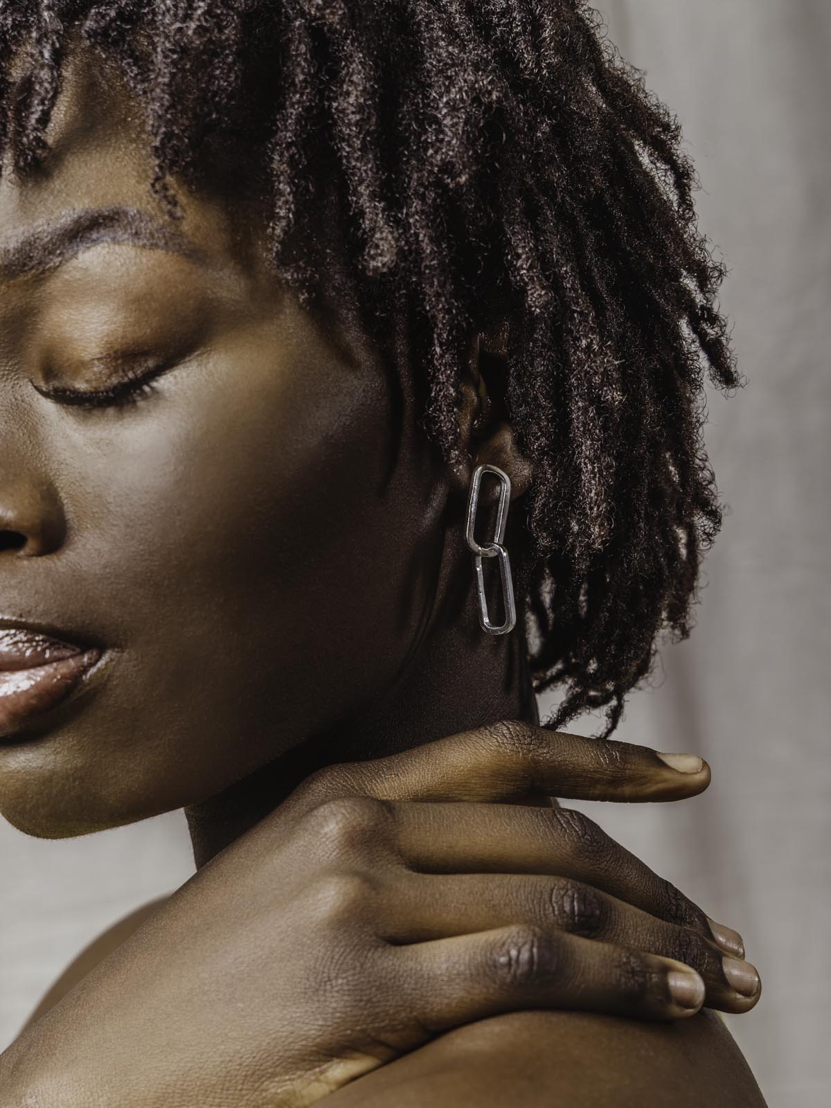 Model wearing silver earrings