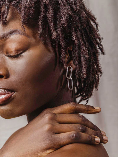 Model wearing silver earrings