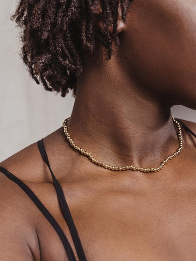 Gold Beaded Choker on Woman