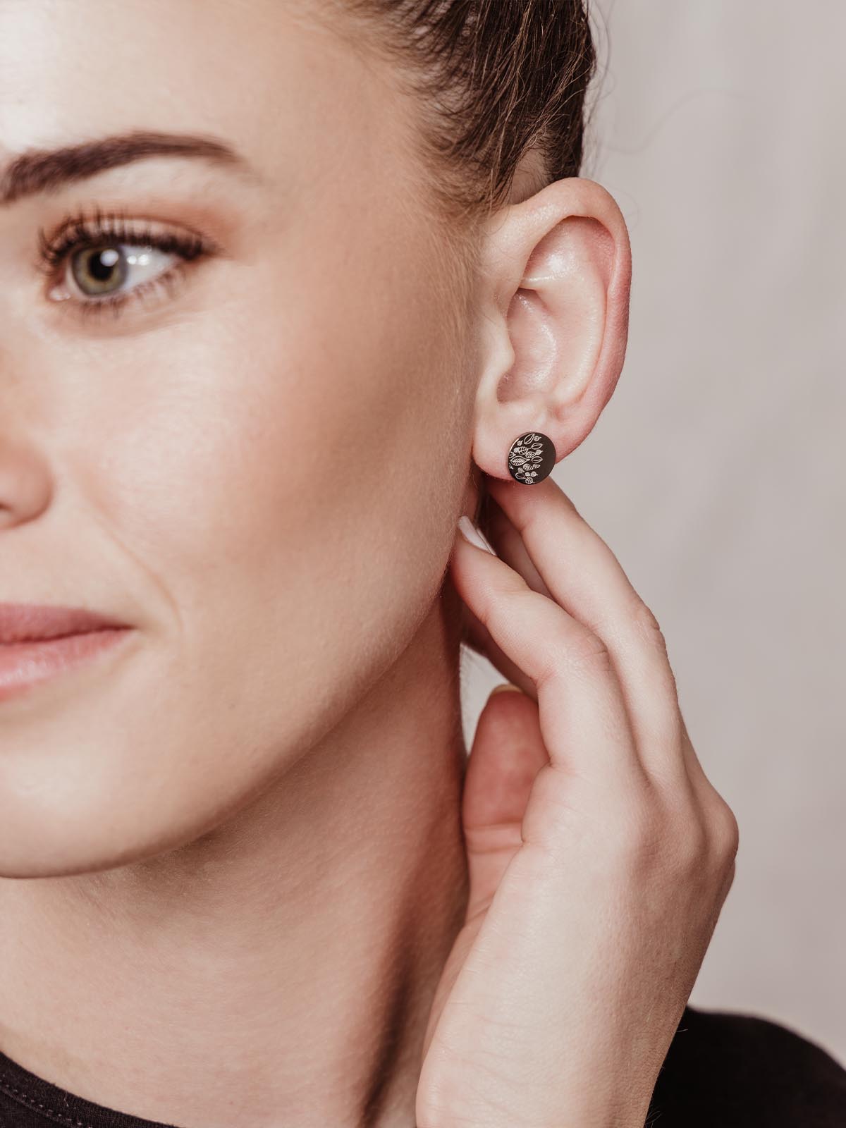 Silver studs with leave engravings worn by model. 